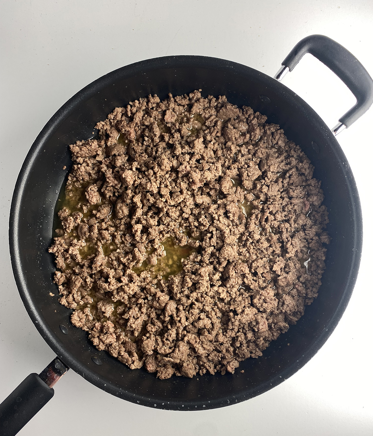 Cooked ground beef in a skillet.