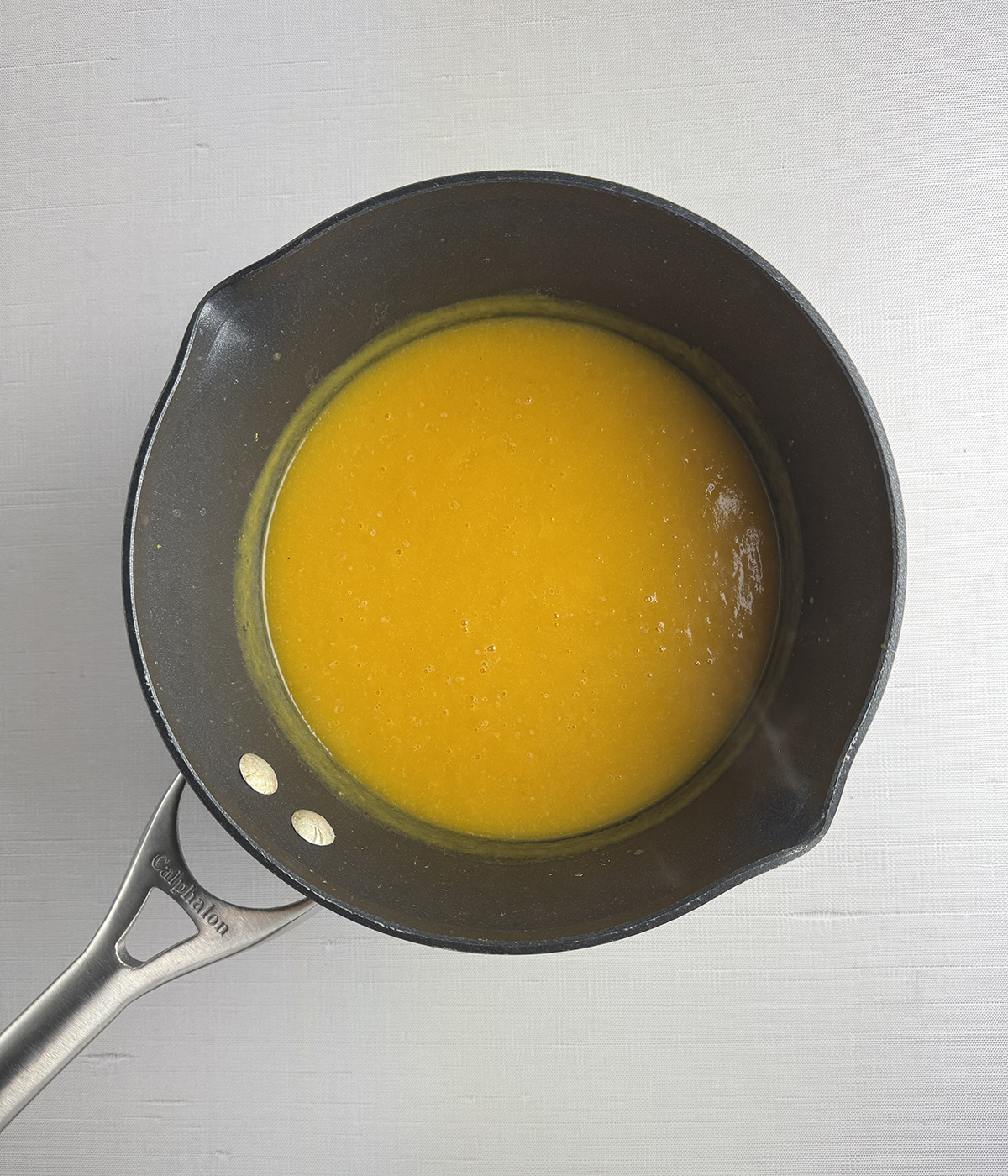 Pureed butternut squash soup in a pot.