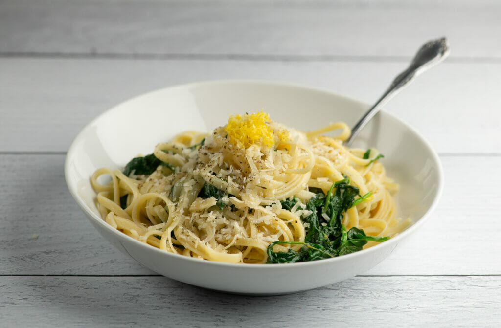 Lemon spinach pasta in a bowl with a fork.