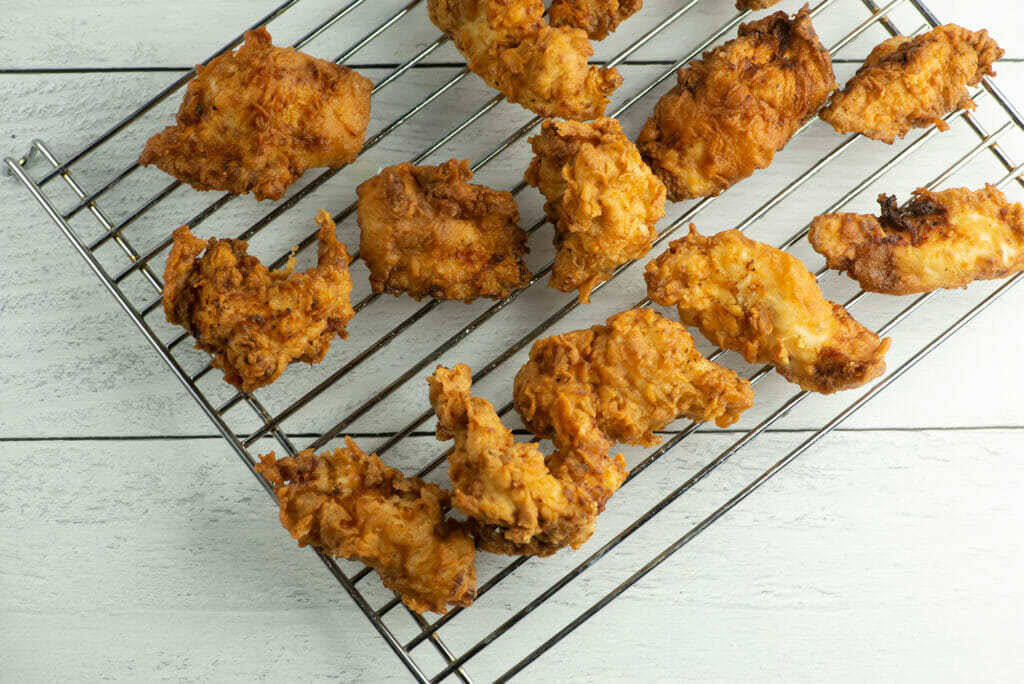 Buttermilk Fried Chicken Tenders cooling on a rack.