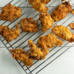 Buttermilk Fried Chicken Tenders cooling on a rack.