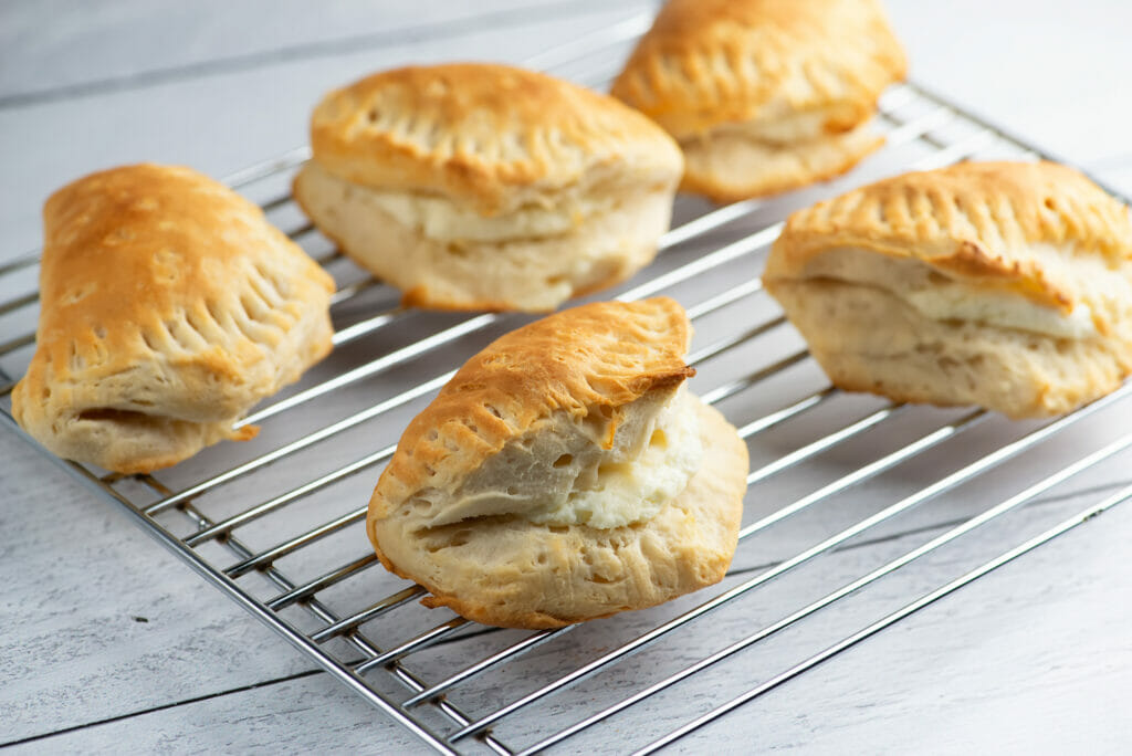 Cream cheese Stuffed Biscuits cooling on a rack.