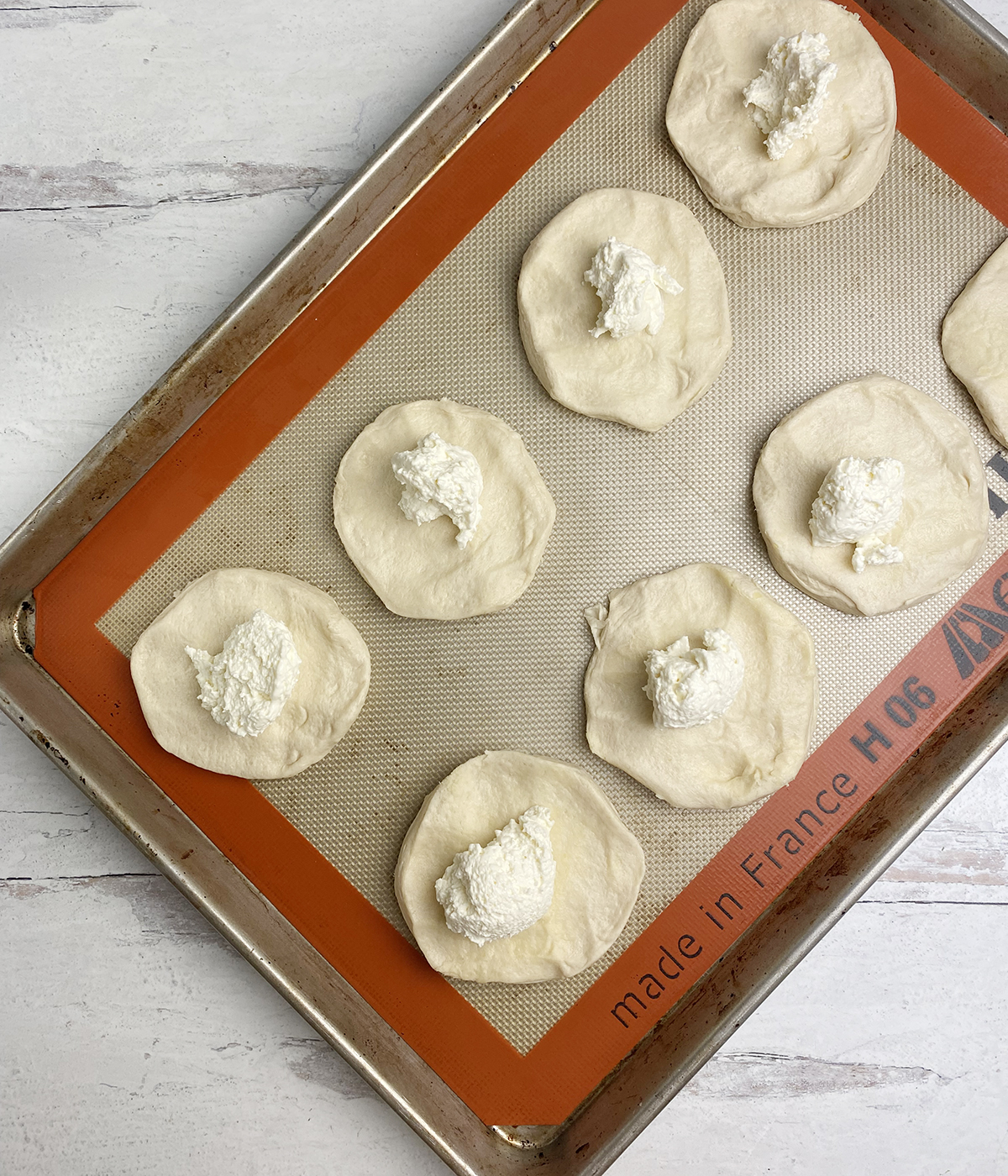 Cream cheese biscuits will filling ready to be folded.