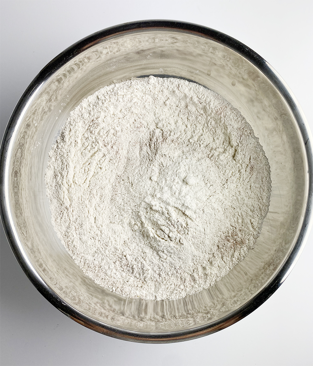 Flour mixture in a metal bowl.