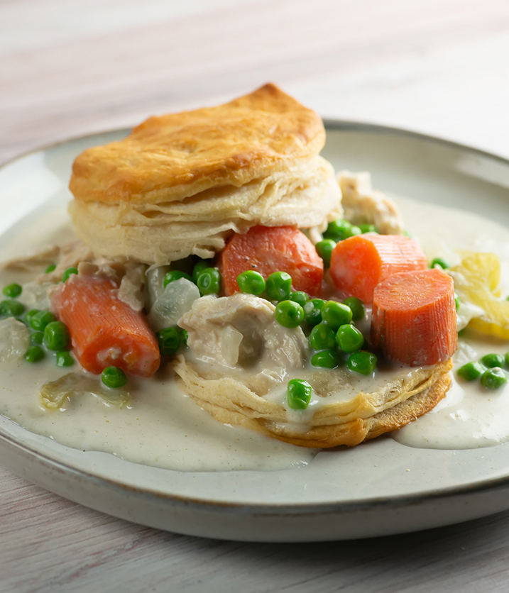 Creamy slow cooker chicken with biscuits on a plate.