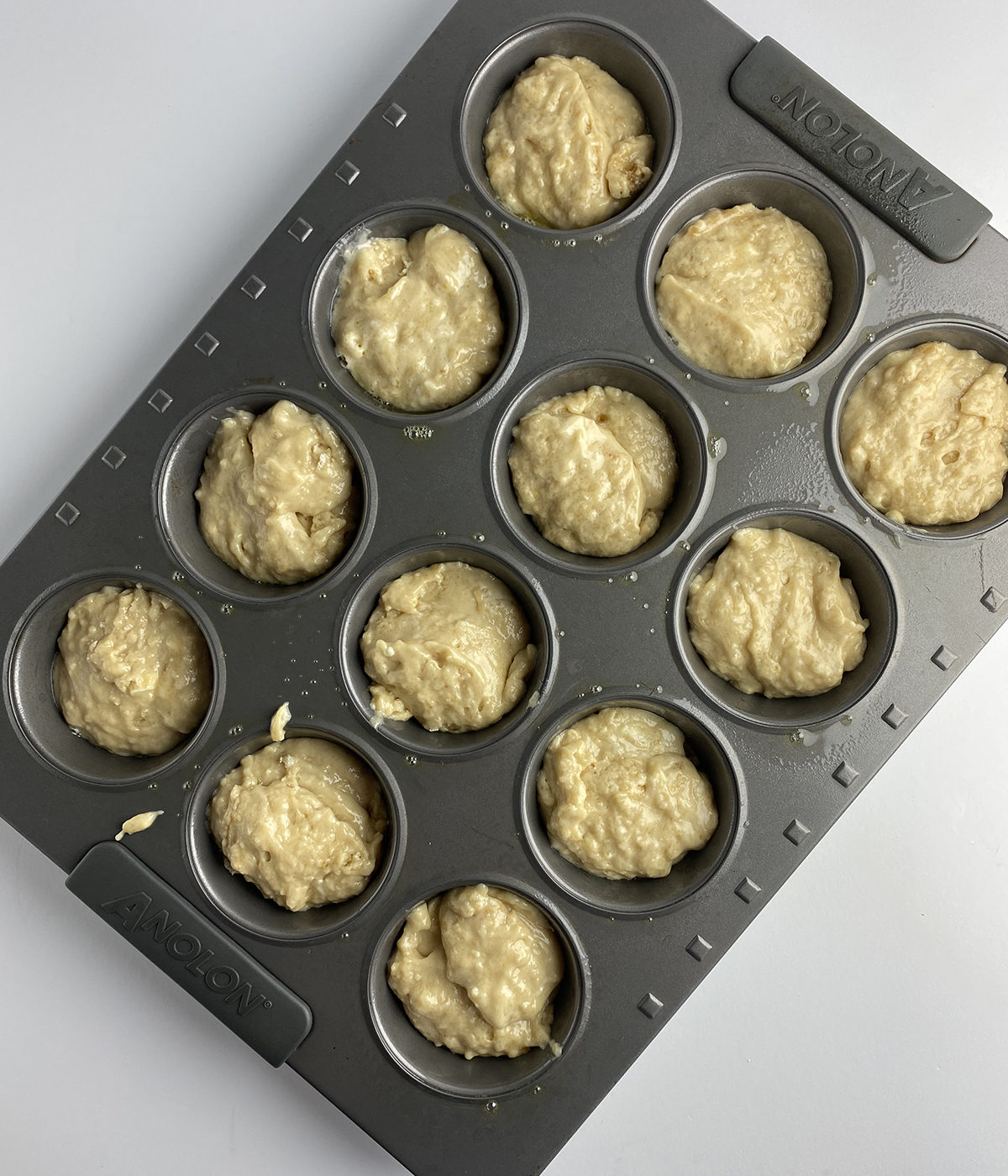 French toast muffin batter in a muffin tin.