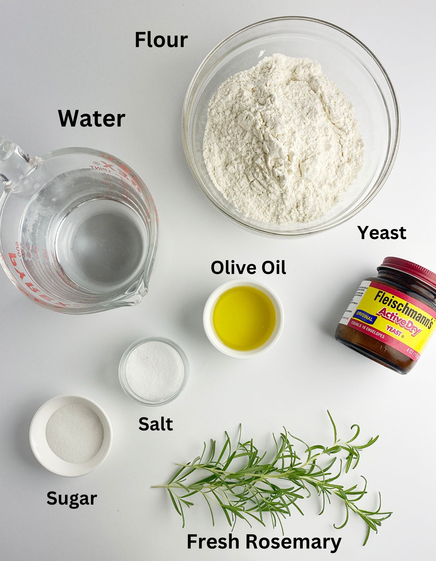 Focaccia ingredients on a white counter.