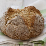 Irish brown bread on a green dish cloth.