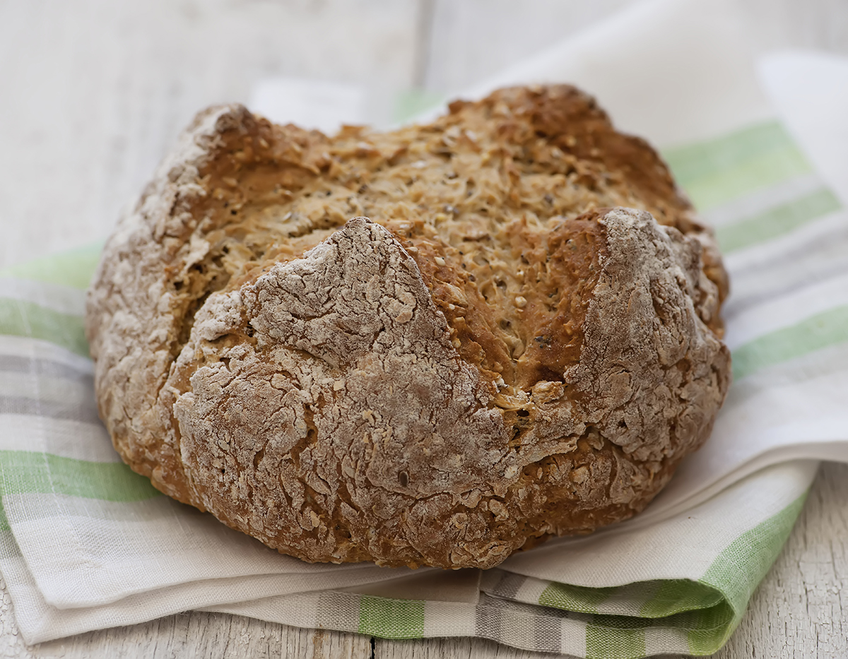 Irish brown bread on a green dish cloth.