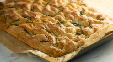 focaccia in sheet pan with parchment