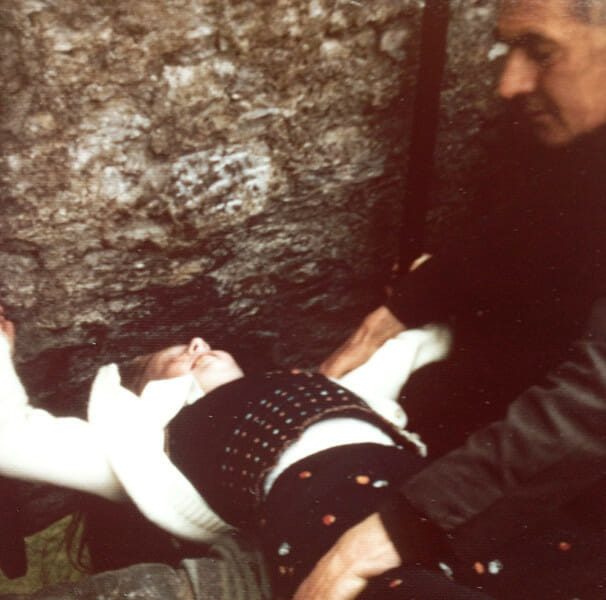 Girl kissing the Blarney Stone in Ireland.