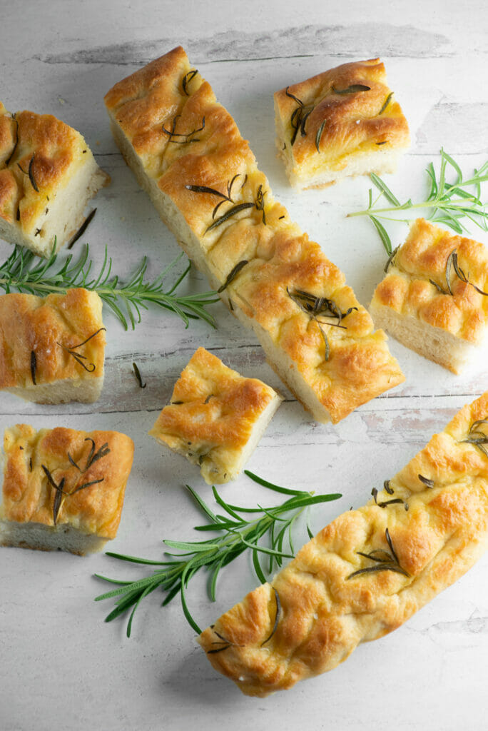 Sliced focaccia on a wooden board.