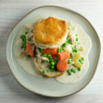 Slow cooker chicken with biscuits on a plate.