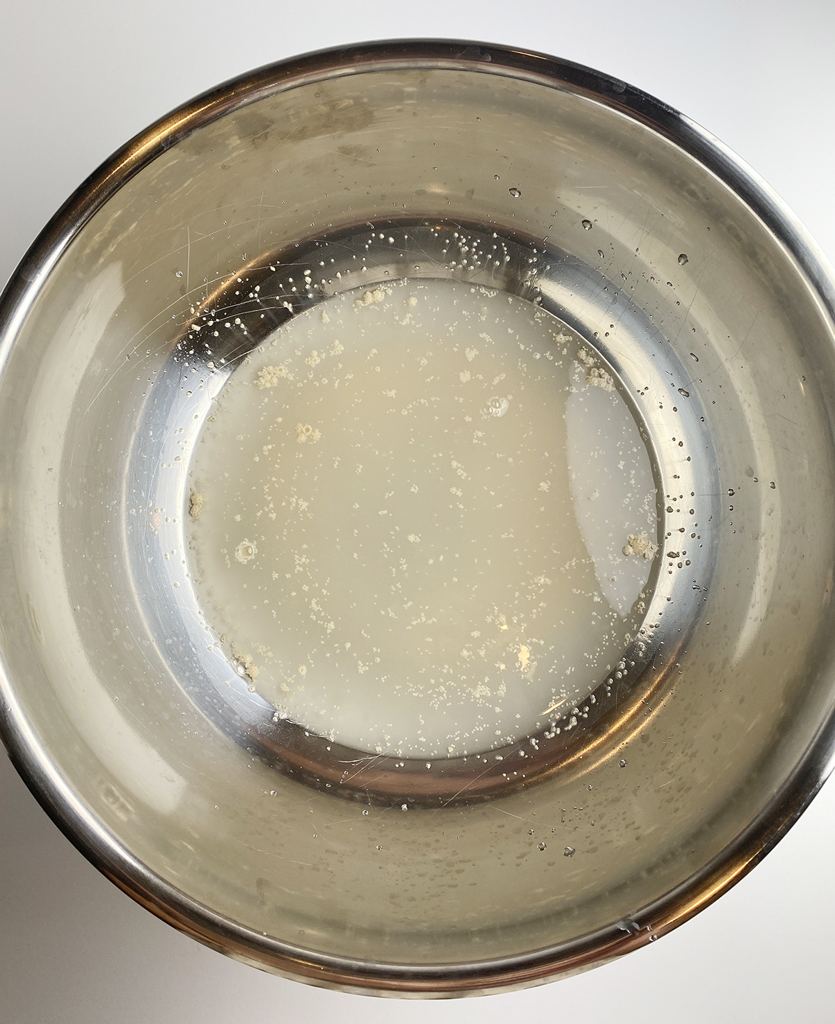 Yeast sugar and water mixture in a bowl.