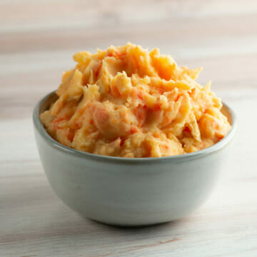 Carrot mashed potatoes in a bowl.