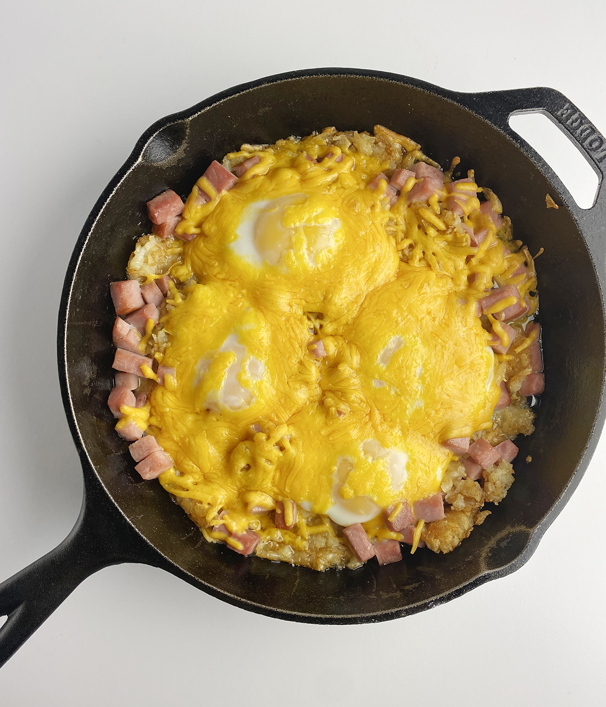 Ham and egg breakfast casserole in a skillet.
