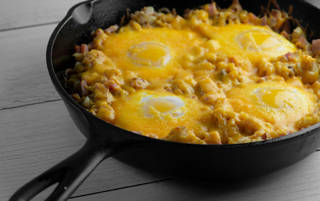 Ham and egg tater tot casserole in cast iron pan.