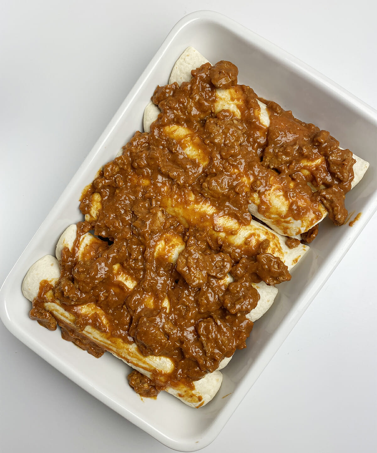 Chili dog casserole with chili topping in a casserole dish.