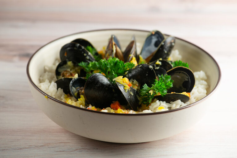 Bowl of mussels in blue cheese sauce.