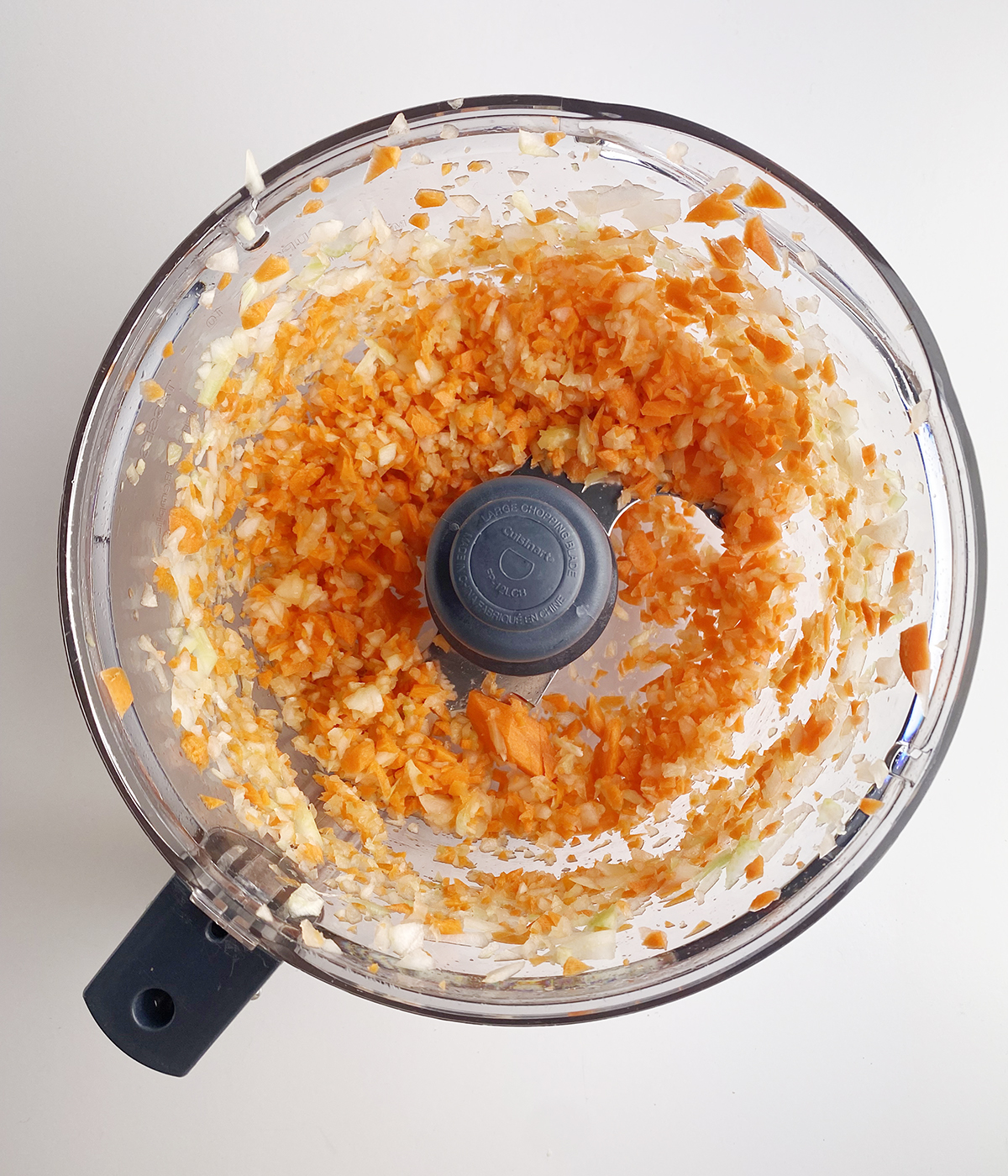 Chopped vegetables in a food processor.