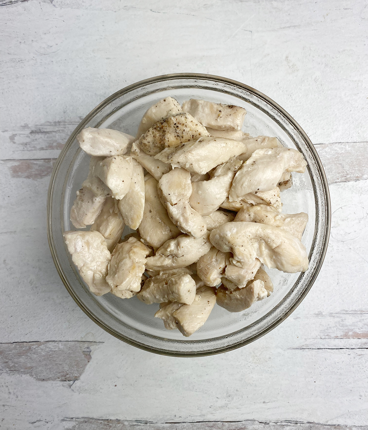 Cooked boneless chicken pieces in a bowl.