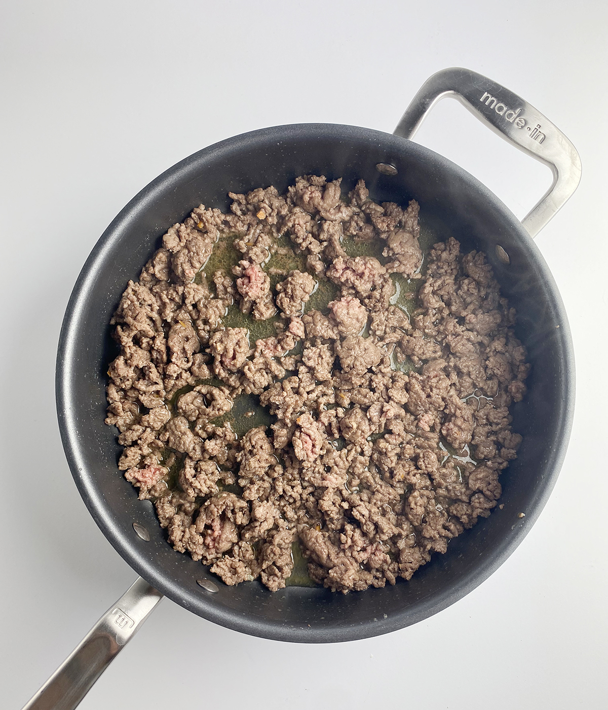 Cooked ground beef in a skillet.