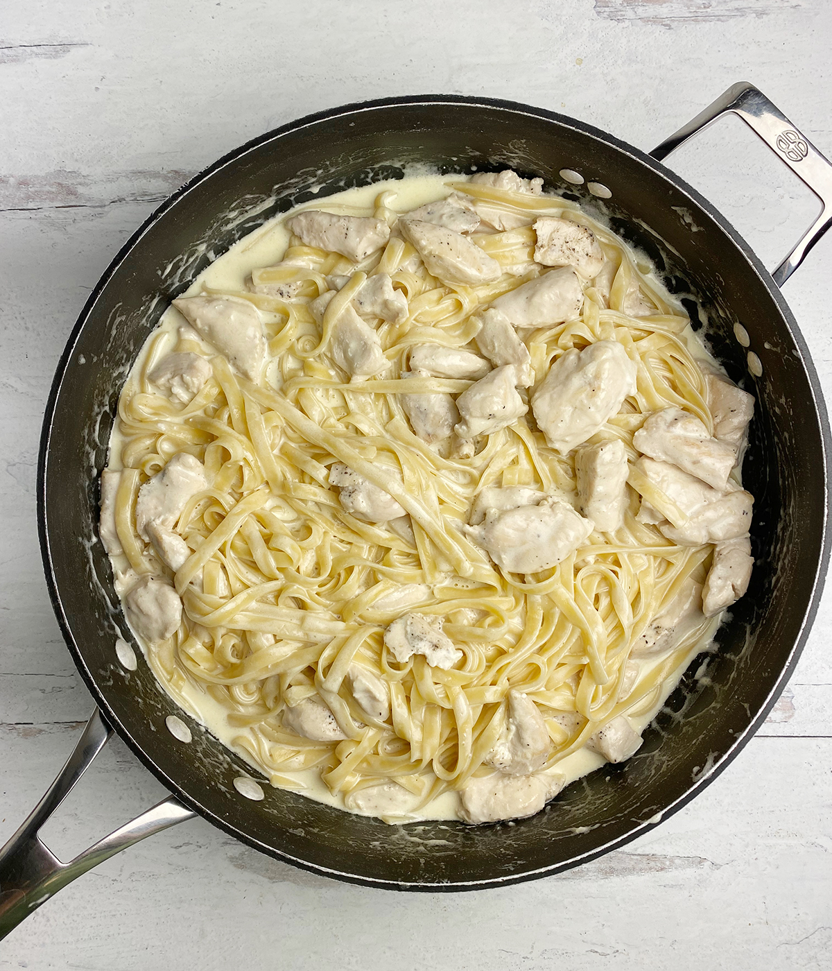 Finished chicken fettuccine Alfredo in a skillet.