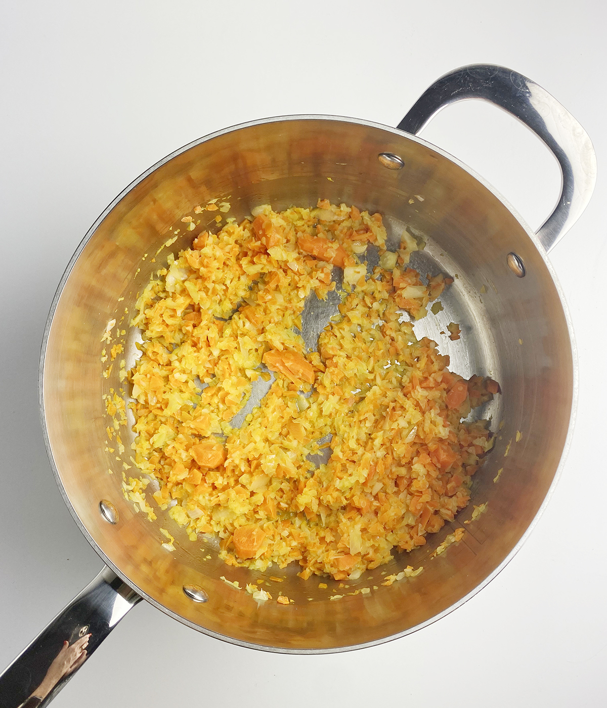 Sauteed vegetables in a pot.