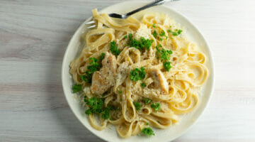 chicken alfredo on plate with fork