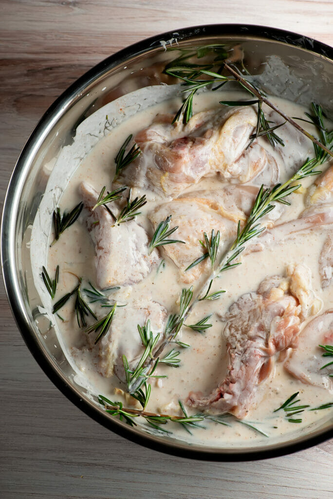 grilled buttermilk rosemary chicken marinating in a bowl