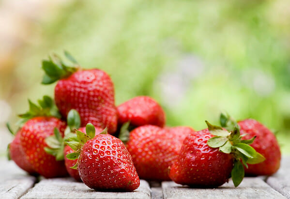 Fresh strawberries oon a wooden table.