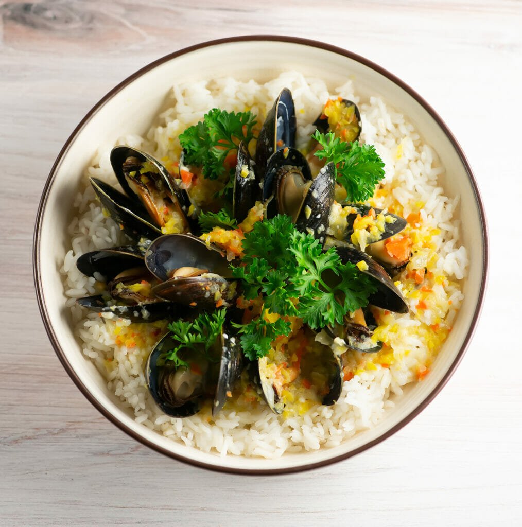 Mussels in blue cheese sauce in a bowl.