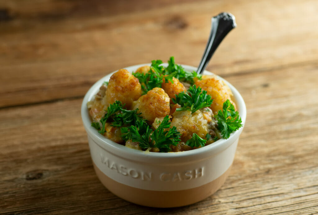 Tater tot shepherd's pie in bowl with spoon.