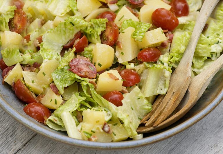 Bacon lettuce and tomato potato salad in a bowl.