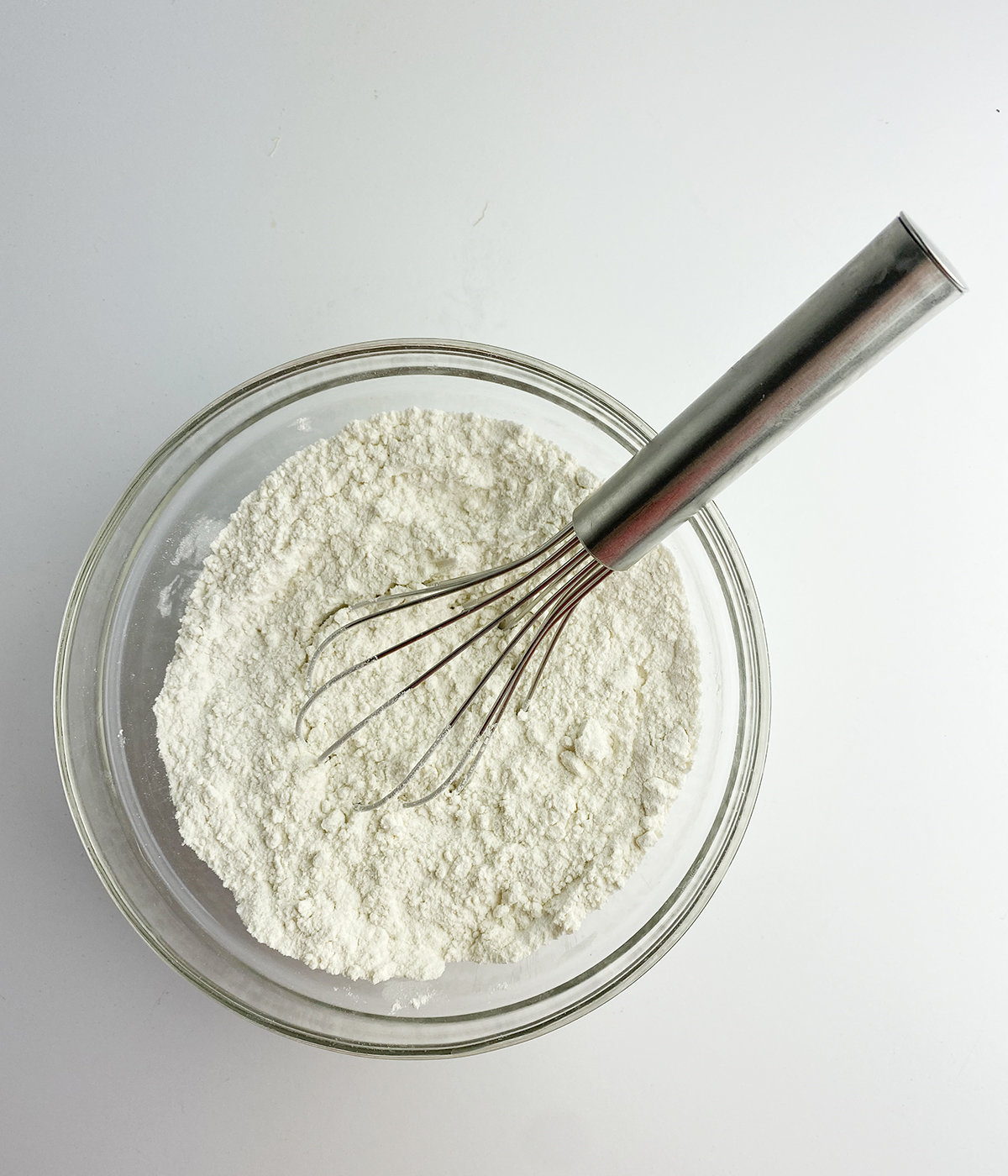 Flour mixture in a bowl with a whisk.