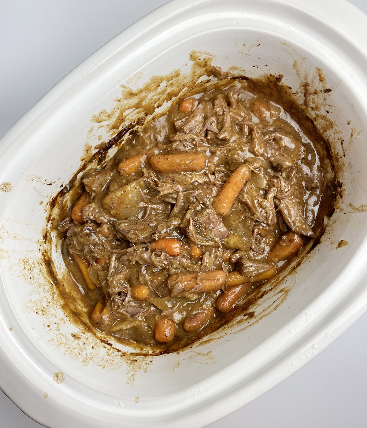 Fully cooked slow cooker coca cola pot roast in a slow cooker.