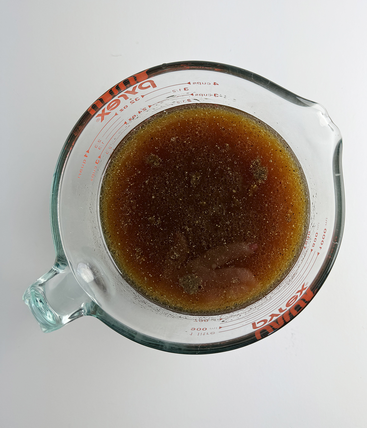 Pineapple steak marinade in a measuring cup.