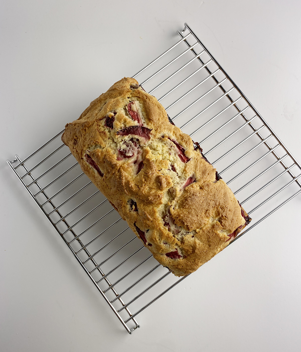 Strawberry bread cooling on a rack.