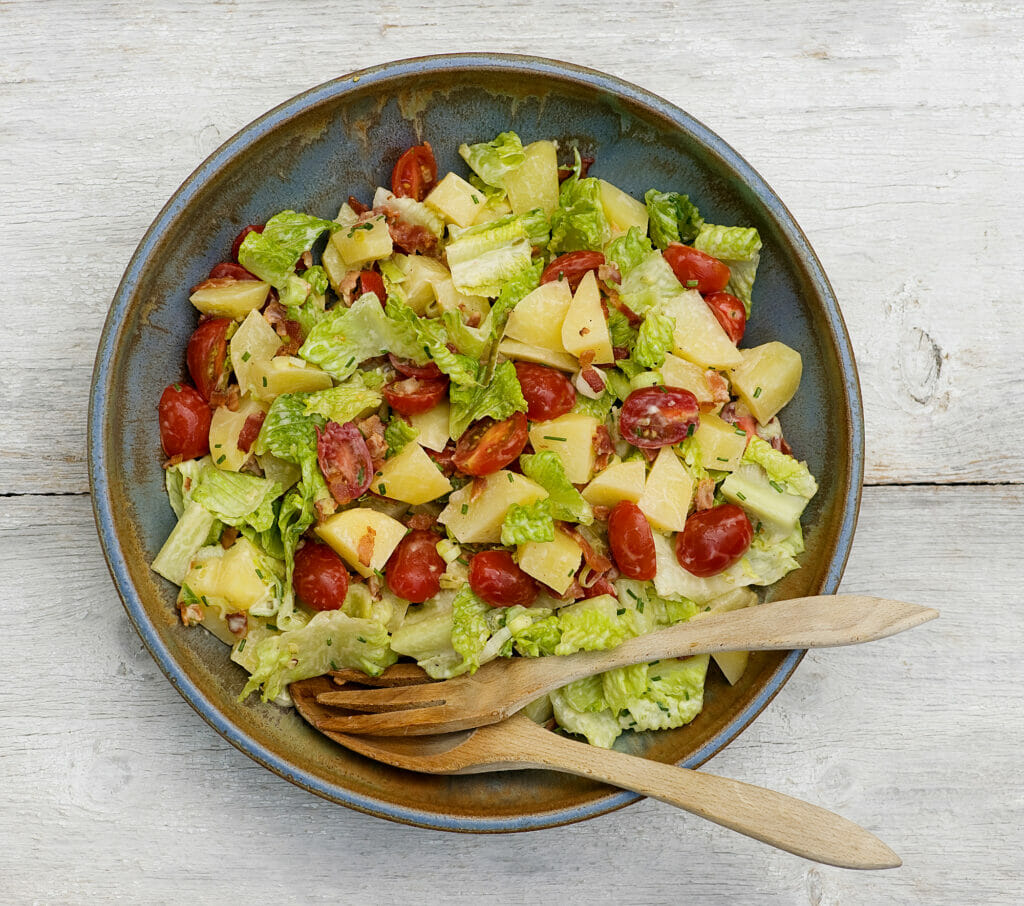 bacon lettuce and tomato potato salad in bowl