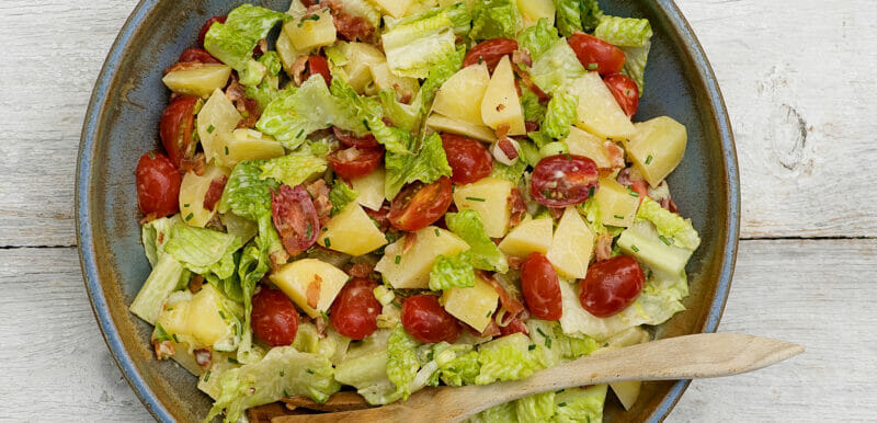 bacon lettuce and tomato potato salad in bowl