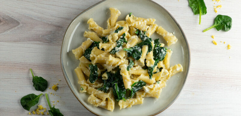 pasta with lemon ricotta spinach sauce on plate
