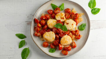scallops with roasted cherry tomato sauce on plate