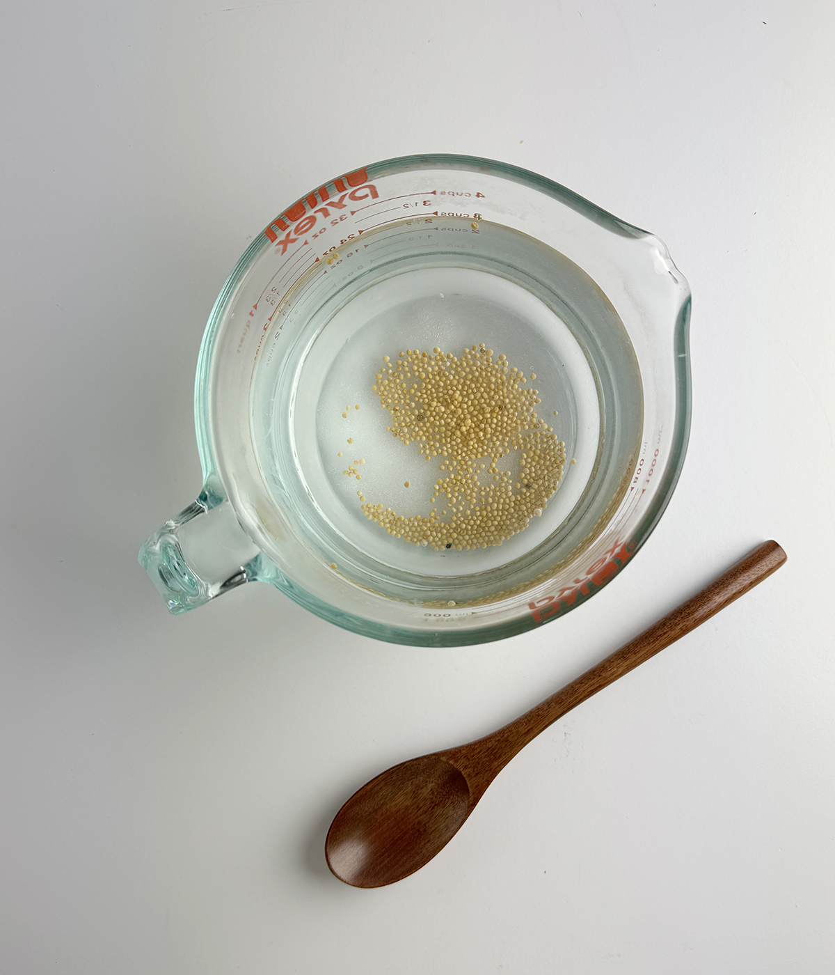 Refrigerator pickle brine in a measuring cup.