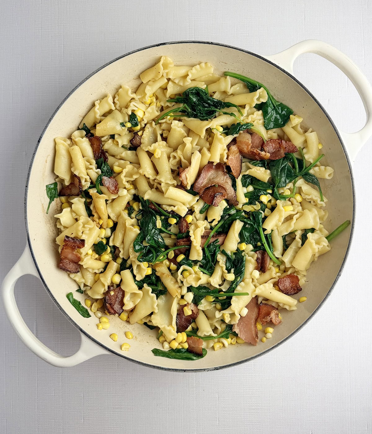 Corn Bacon and Pasta in a skillet.