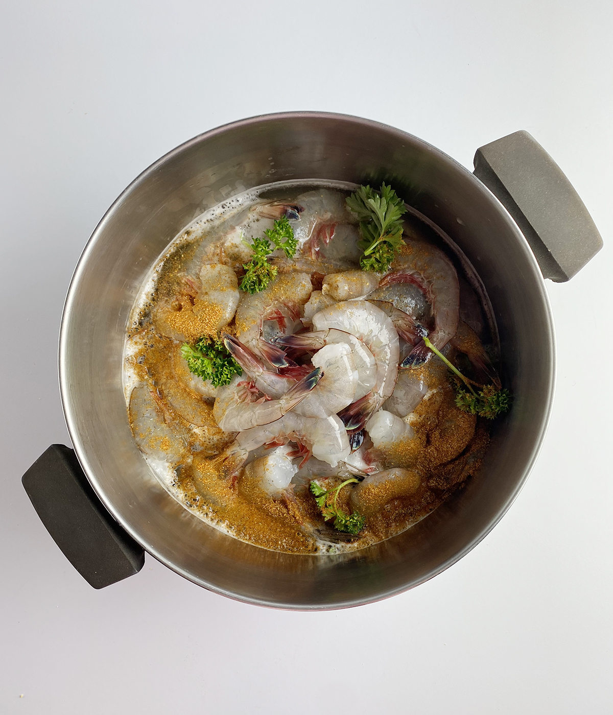 Shrimp cooking in beer in a pot.