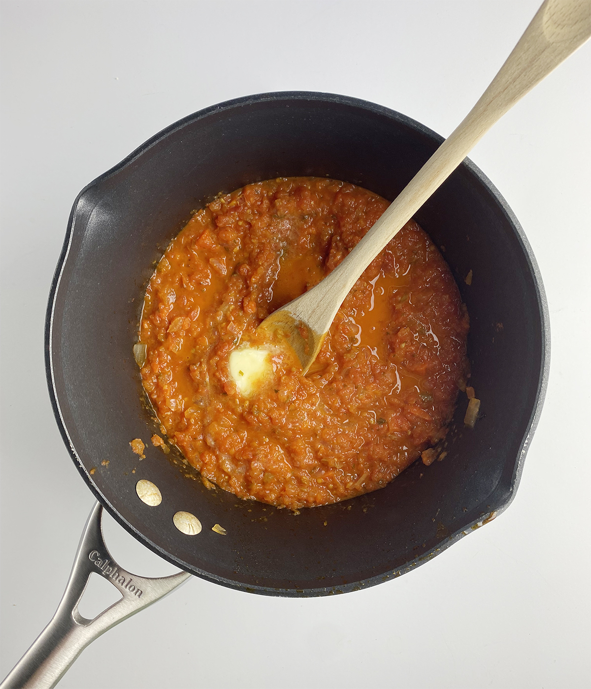Tomato sauce in a pot with butter melting