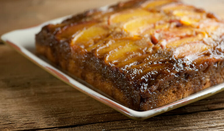 Peach upside down cake on a square platter.