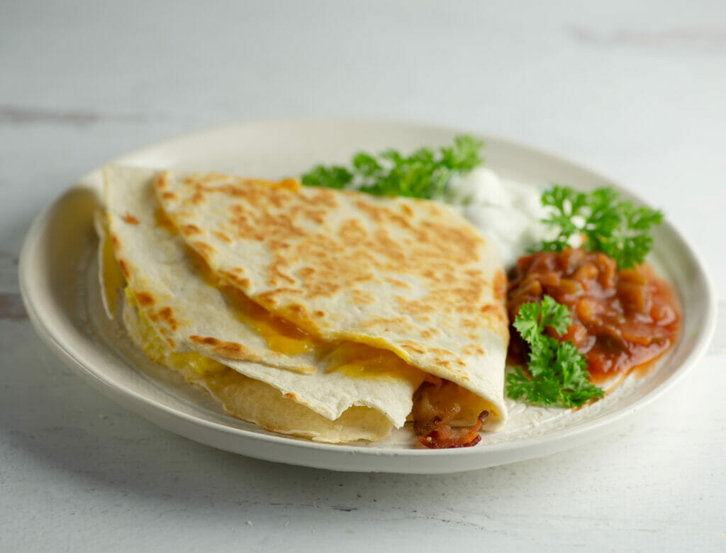 Fried breakfast quesadilla on a plate.