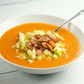 Bacon Lettuce and Tomato Soup in a bowl with a spoon.with a spoon.