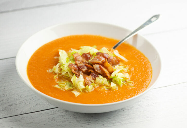 Bacon Lettuce and Tomato Soup in a bowl with a spoon.with a spoon.